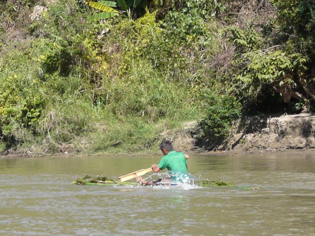 boy on bamboo raft